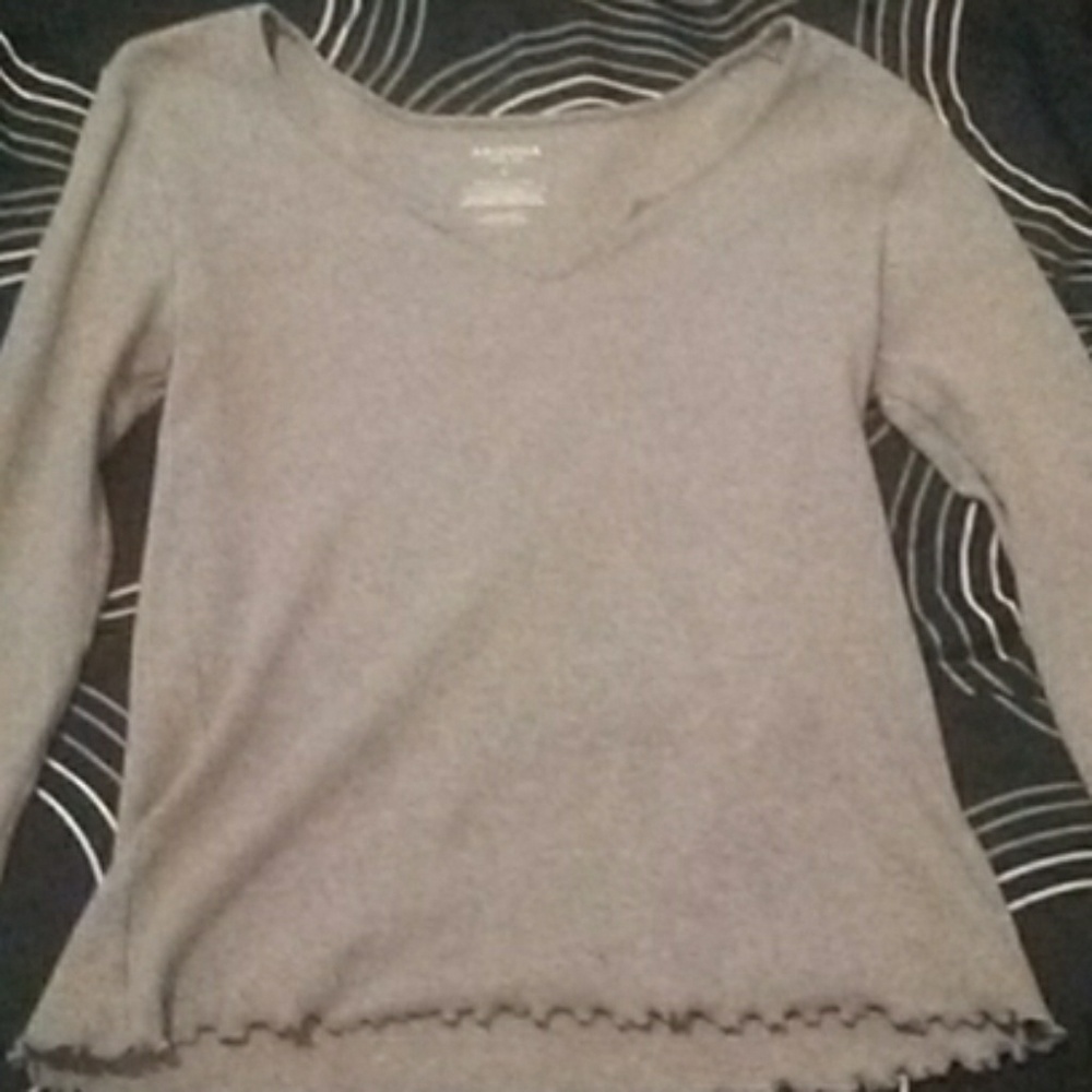 A grey crop top with a v-neck
